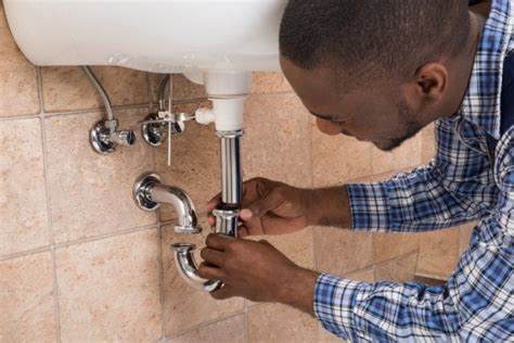man fixing sink