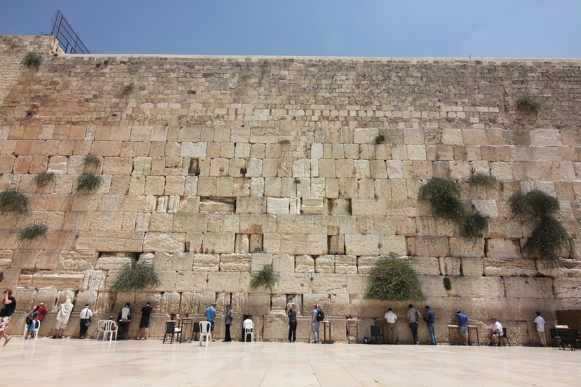 people standing next to a wall