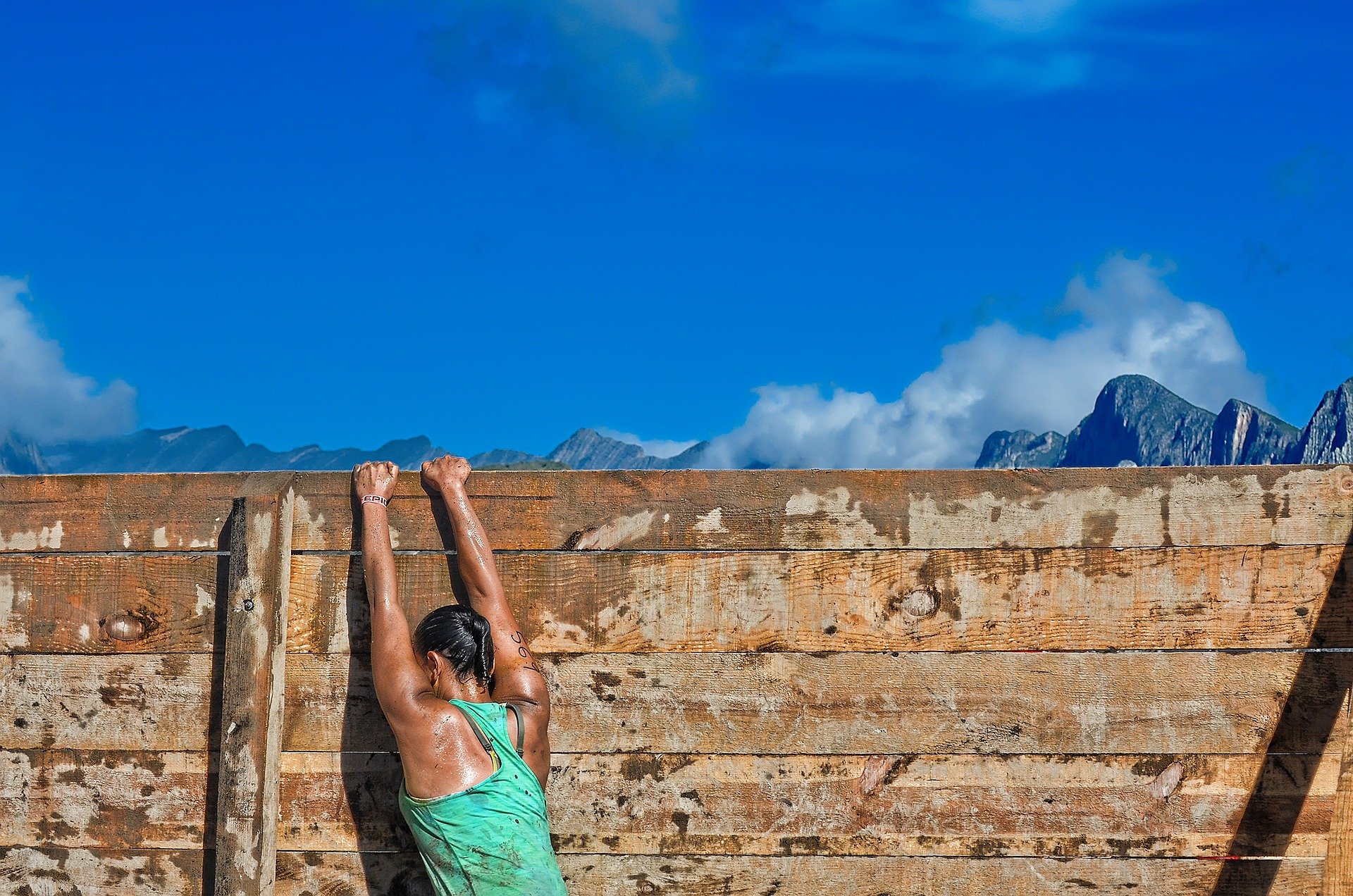 woman on an obstacle course with mountains in the background