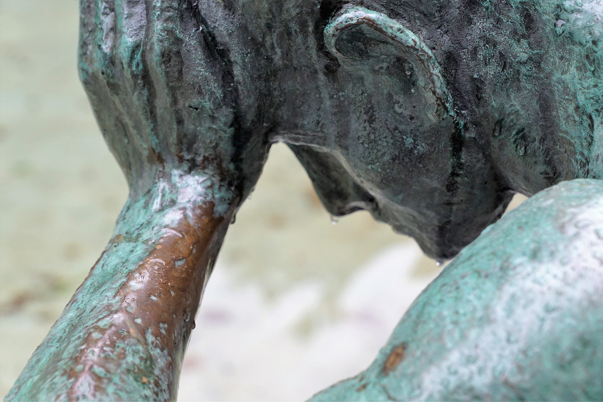 a stature of a man holding his head in doubt